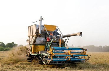 harvesting machinery working in rice field