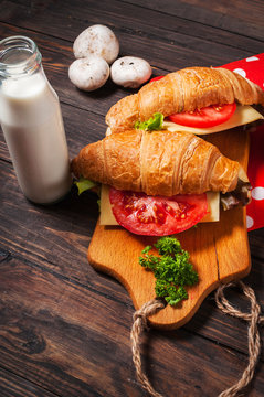 vegetarian croissant cheese breakfast on wood background