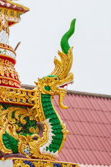 Fototapeta na wymiar Traditional Thai style naga art on the roof in temple