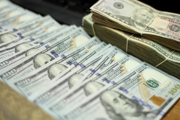 Hundred Dollar bills laid out in a line.	