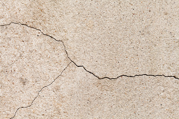 Obraz premium Cracked beige wall texture. Yellow sand stone with a crack