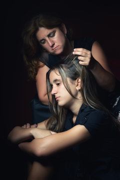 Sad teenage girl and her  worried mother