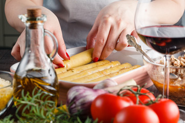 Woman making cannelloni