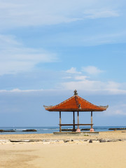 tradition beach pavilion at bali in sunny day.