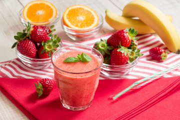 Strawberry orange banana smoothie and ingredients. 