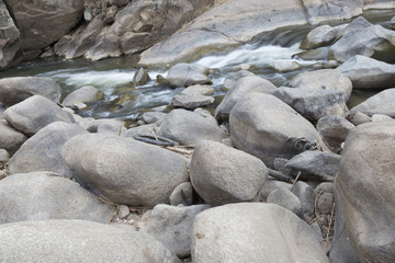 water stream through stone in creek