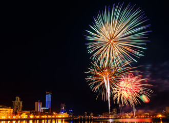 fireworks over the night city and city pond Yekaterinburg city center. Celebrating the victory of May 9, 2016