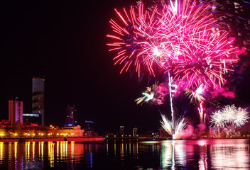 fireworks over the night city and city pond Yekaterinburg city center. Celebrating the victory of May 9, 2016