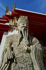 Stone sculpture of Chinese guardian at the entrance of Wat Pho,