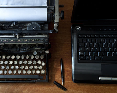 Old typewriter with laptop, concept of technology progress