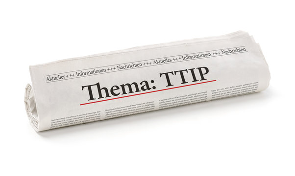 Zeitungsrolle mit der Überschrift Thema TTIP