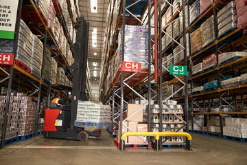 Lowering stock in a distribution warehouse using aisle truck