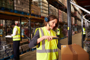 Woman using a barcode reader in a distribution warehouse