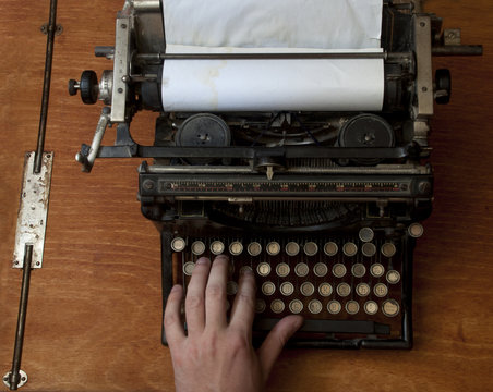 Man typing on an old typewriter, with a retro effect, copyspace
