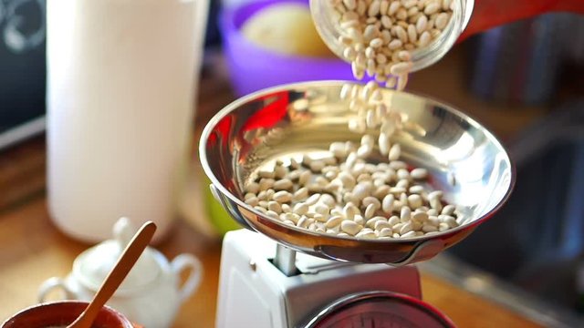 Pouring bean on the weight, super slow motion
