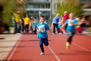 Young preschool children, running on track in a marathon competi