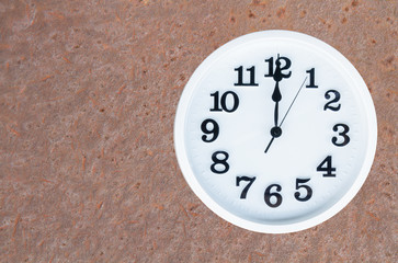 Clock on steel rusty background
