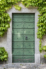  Old Green Garden Door: An old green painted wood door to a garden in Varenna, Italy - 110187844