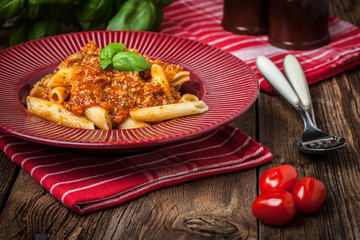 Penne a bolognese on white plate.