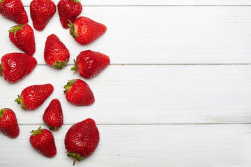 strawberry fruits on wooden background
