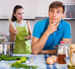 Unpleased person criticizing young spouse