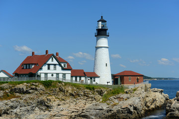 Fototapeta na wymiar Portland Head Lighthouse and keepers' house in summer, Cape Elizabeth, Maine, USA