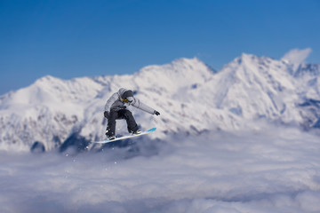 Fototapeta na wymiar Snowboard rider jumping on mountains. Extreme snowboard freeride sport.