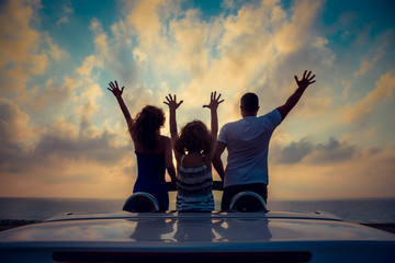 Silhouette of family relaxing on the beach