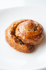 Baked roll on a white plate