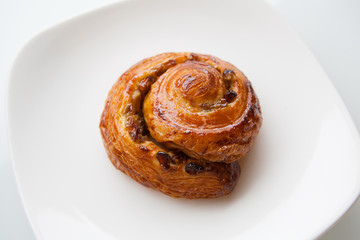Baked roll on a white plate