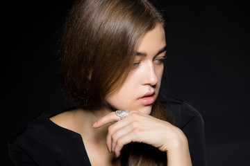 Fototapeta premium Portrait of a girl with diamonds on black dackground