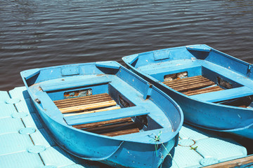 Two rowing boats are on dock near water
