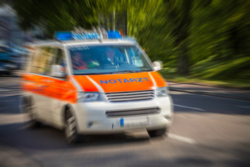 german emergency ambulance car drives on the street