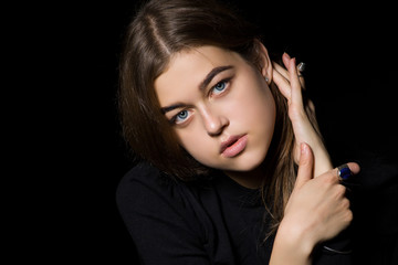 Fototapeta premium Portrait of a girl with diamonds on black dackground.