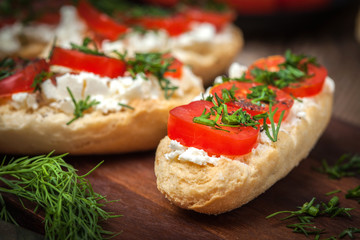 Delicious bruschetta with tomatoes, feta cheese, dill and spice