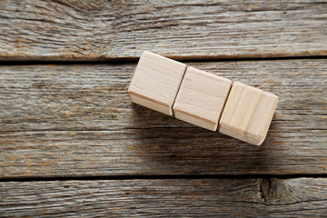 Wooden toy cubes on a grey wooden table