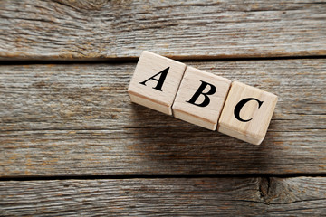 Wooden toy cubes on a grey wooden table