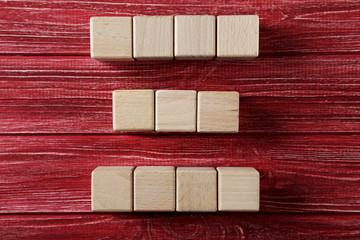 Wooden toy cubes on a red wooden table