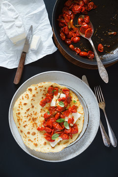 Omelet with roasted cherry tomatoes and  white cheese