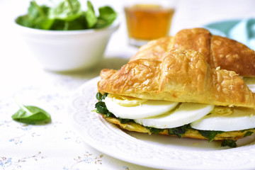 Croissant with spinach and boiled egg.