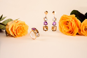 Jewelry gold set of ring and earrings with pink and yellow topaz
