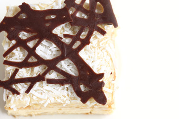 isolated slice of decorated with chocolate napoleon cake, served, copy space