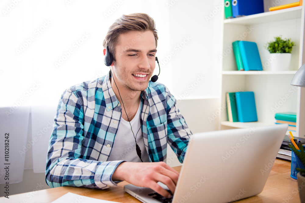 Wall mural happy cheerful young worker of call center in head-phones