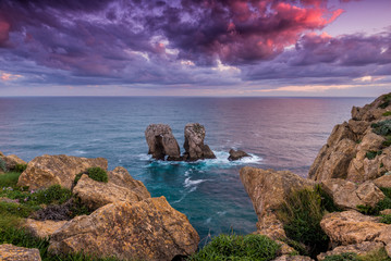 Naklejka premium Sunrise at the coast, ocean and rocks in Cantabria, Spain
