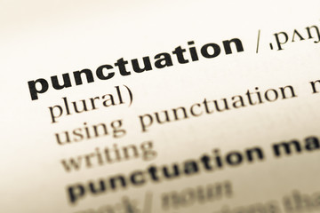 Close up of old English dictionary page with word punctuation