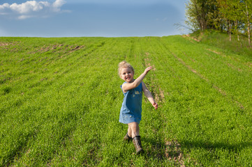 happy girl jumping 4 years in the field