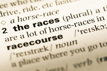 Close up of old English dictionary page with word the races