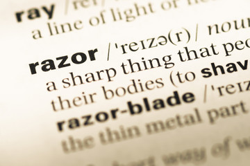 Close up of old English dictionary page with word razor