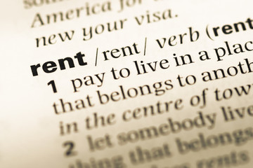 Fototapeta premium Close up of old English dictionary page with word rent
