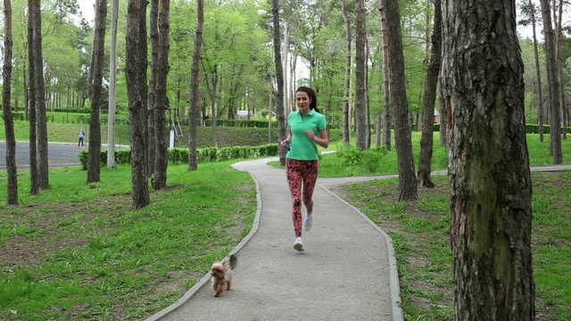 The beautiful young girl jogging in the park.